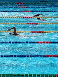 Swimmers racing in an olympic sized pool